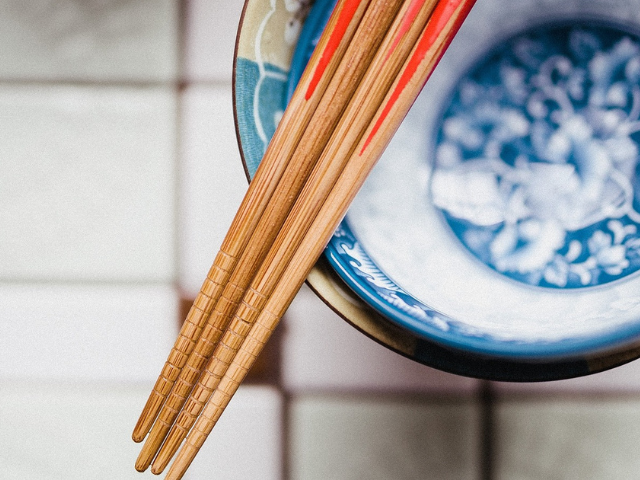 Overused wooden chopsticks with signs of wear and potential mold