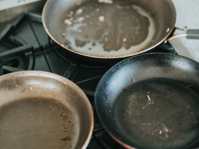 Old scratched non-stick pan with peeling coating